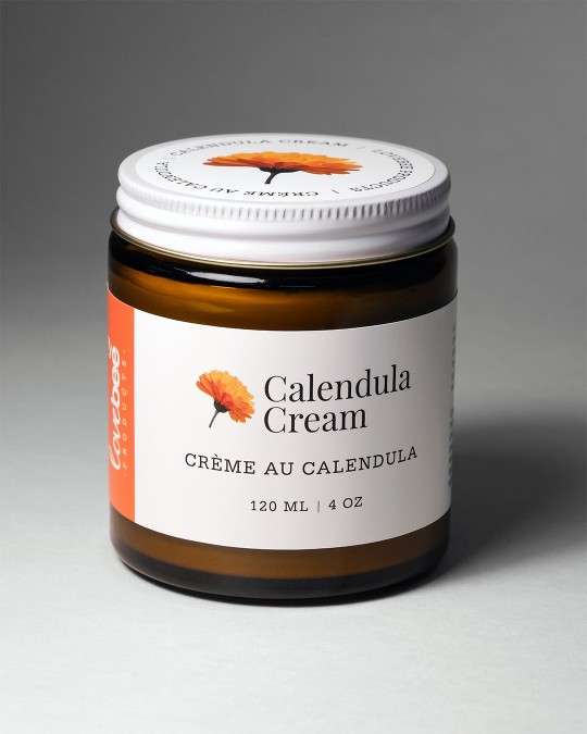 An amber glass jar of natural Calendula Cream