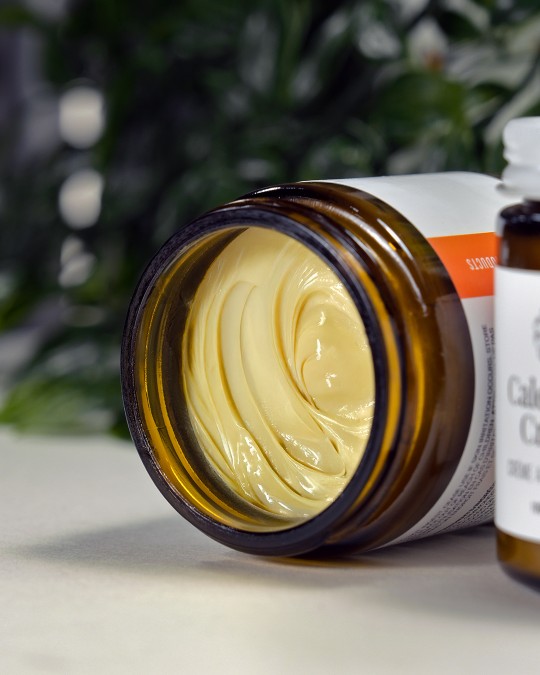 An open jar of calendula cream