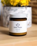 An amber glass jar of baby paste