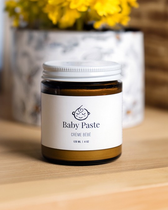 An amber glass jar of baby paste