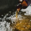 Lavender Bath Oil open and being poured