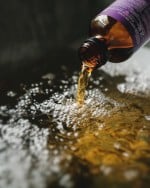 Lavender Bath Oil open and being poured