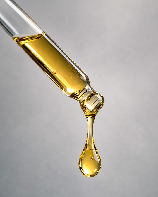 Beard Oil being dispensed from a glass dropper