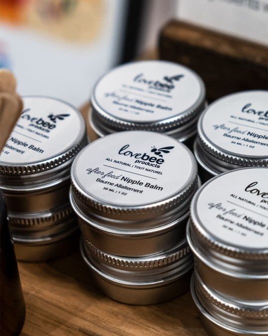 A stack of Afterfeed nipple balms on a shelf