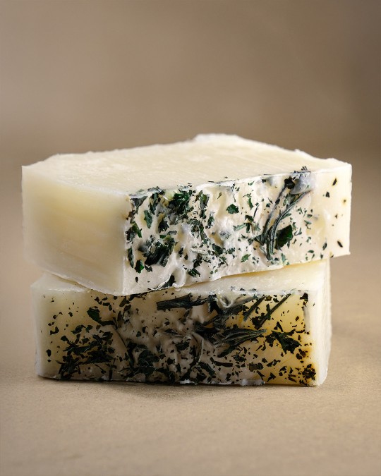 Two stacked rosemary and mint natural soap bars
