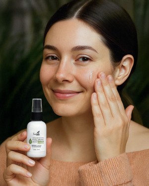A young woman applies Lovebee's natural Hyaluronic Acid Serum to her face