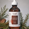 An amber glass bottle with white pump of Cedarwood and Rosemary liquid hand soap